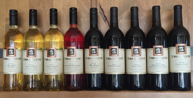 Line up of Torr Na Lochs Vineyard Wine Bottles